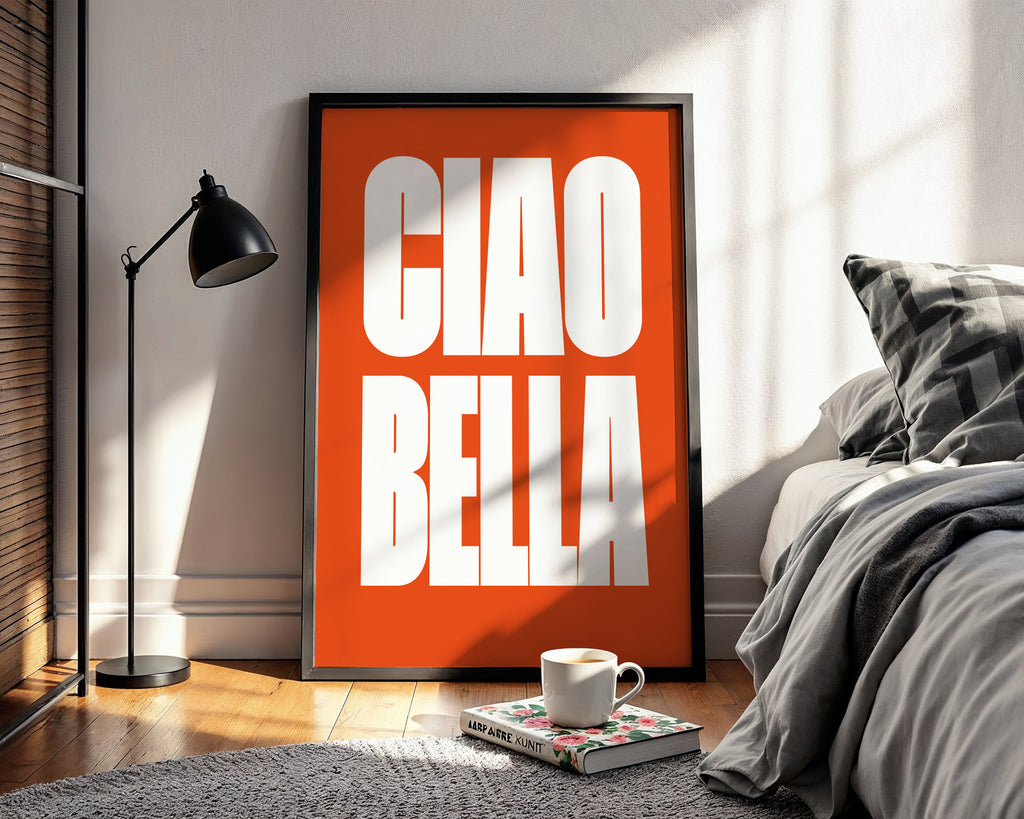 Orange framed poster with 'CIAO BELLA' in a bedroom setting