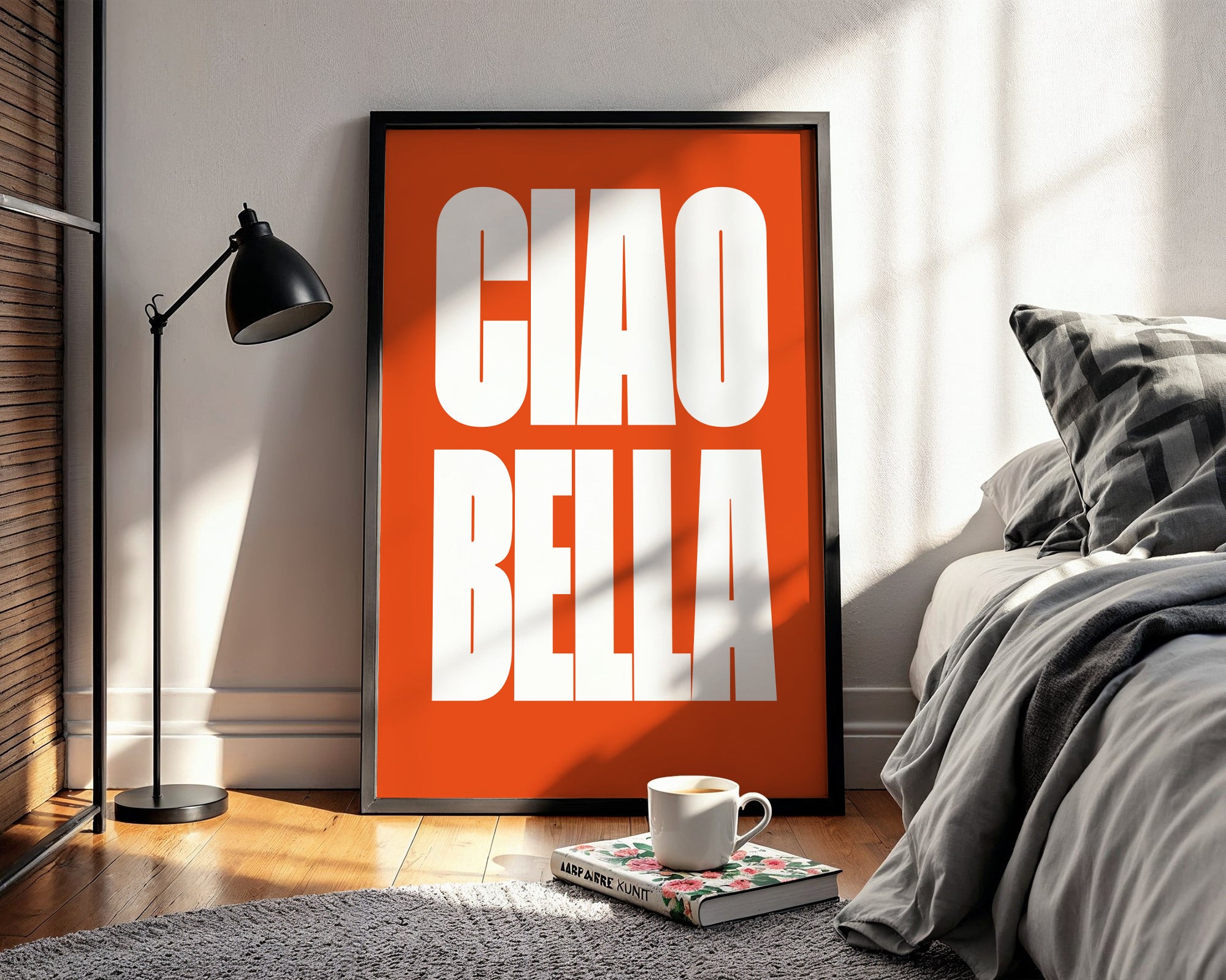 Orange framed poster with 'CIAO BELLA' in a bedroom setting
