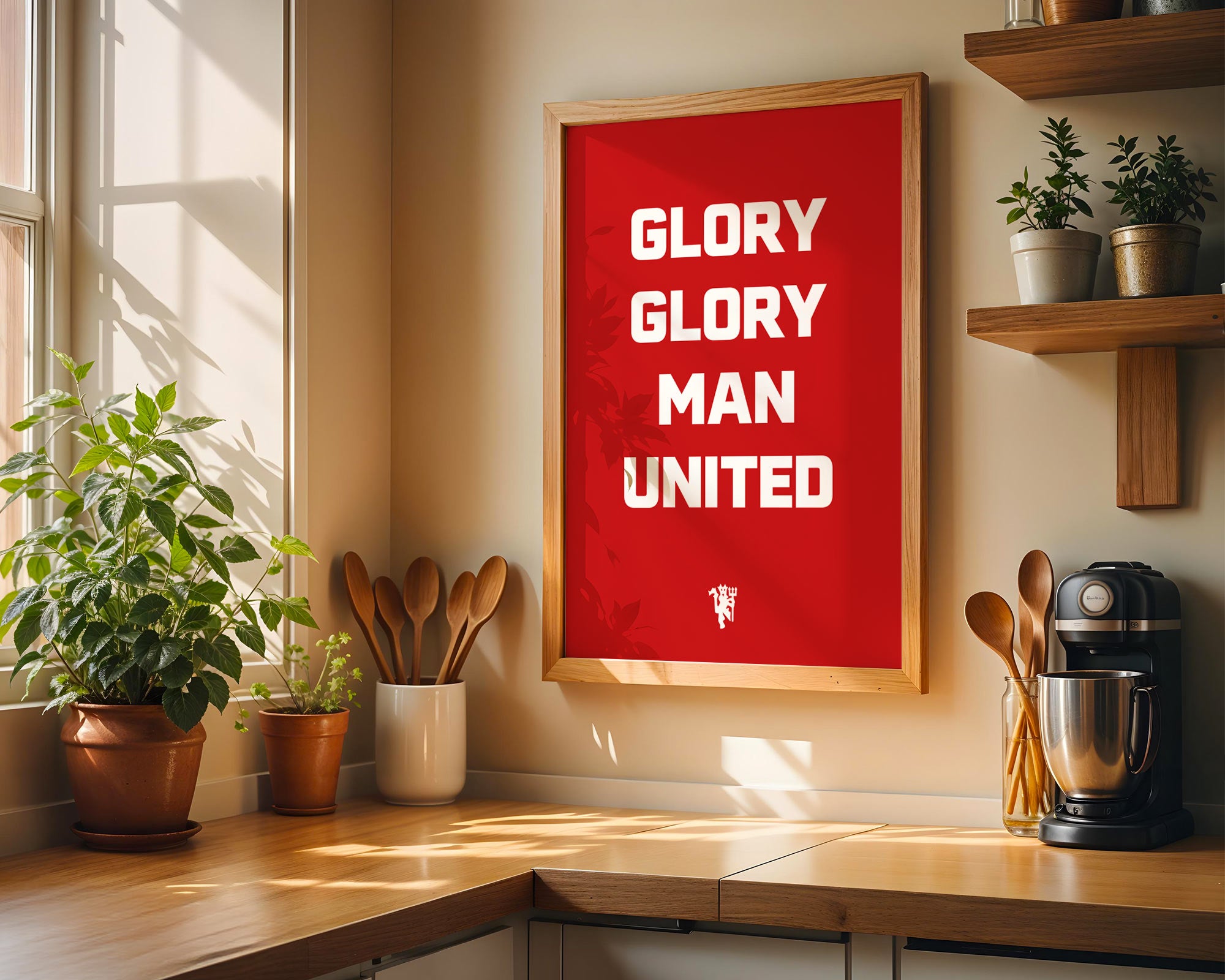 Kitchen with a framed poster reading 'GLORY GLORY MAN UNITED' on a wall.