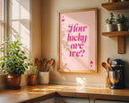 Kitchen corner with a framed poster reading 'How lucky are we?' on a wall.