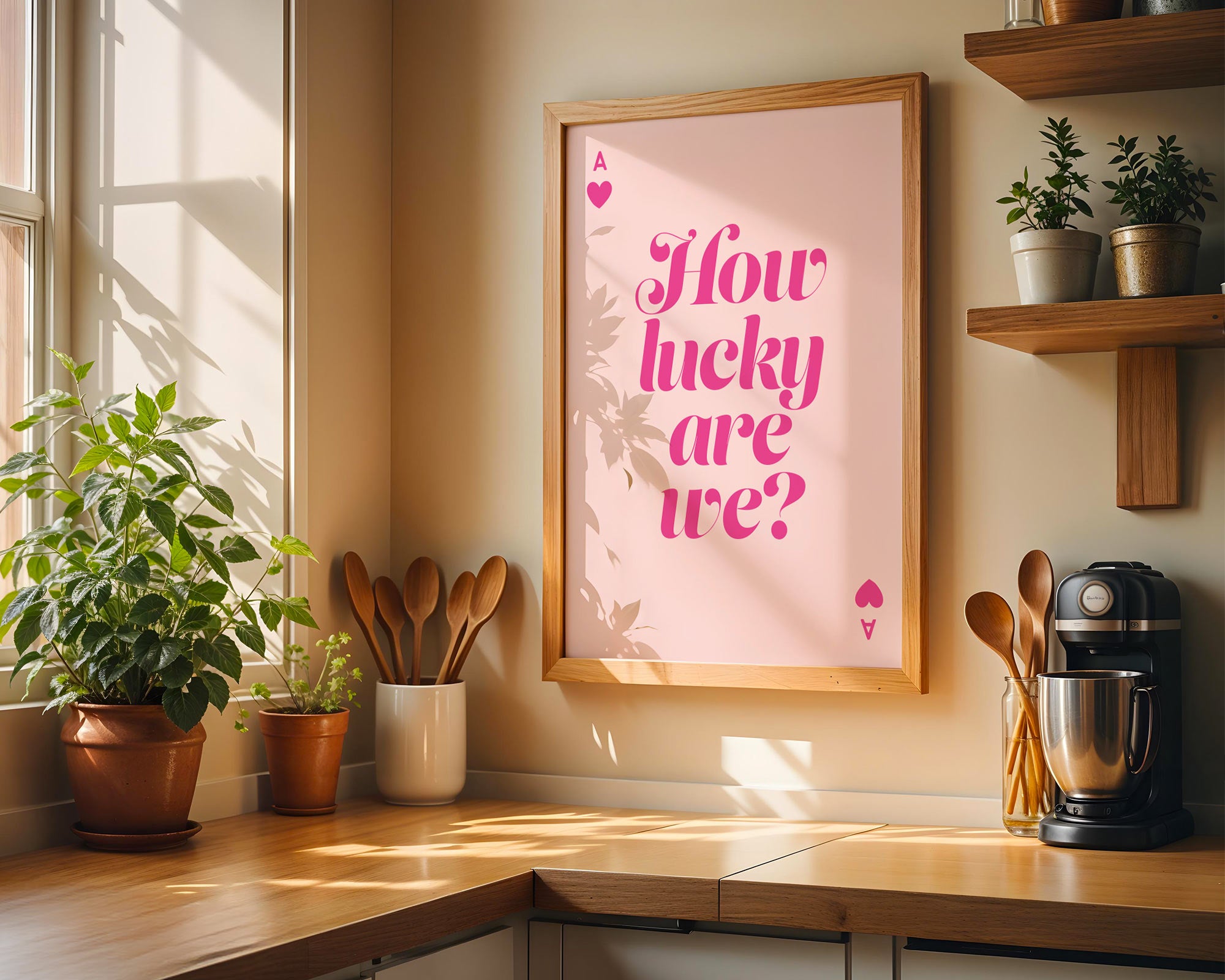 Kitchen corner with a framed poster reading 'How lucky are we?' on a wall.