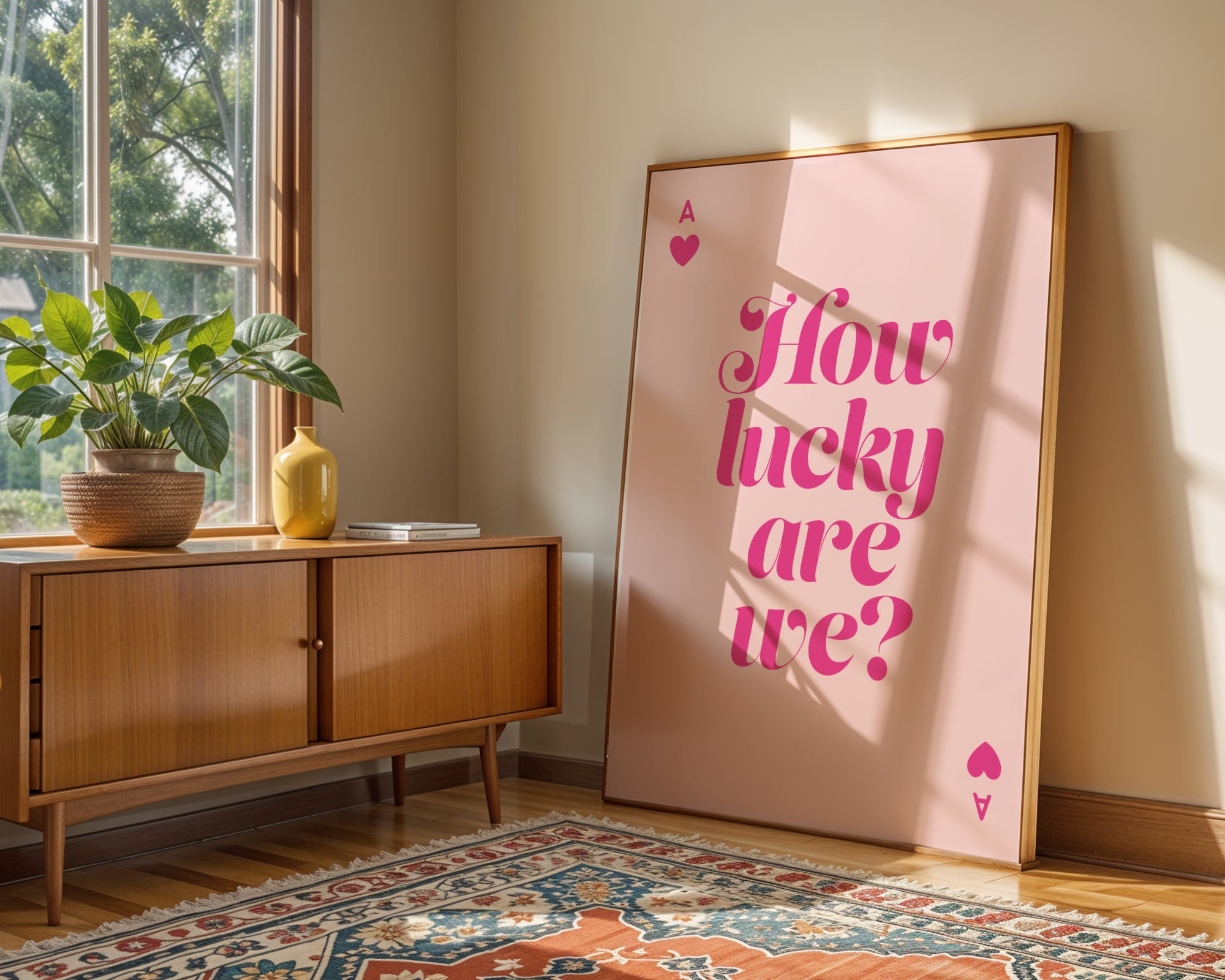 Room interior with a wooden sideboard, plant, and large pink poster with text.