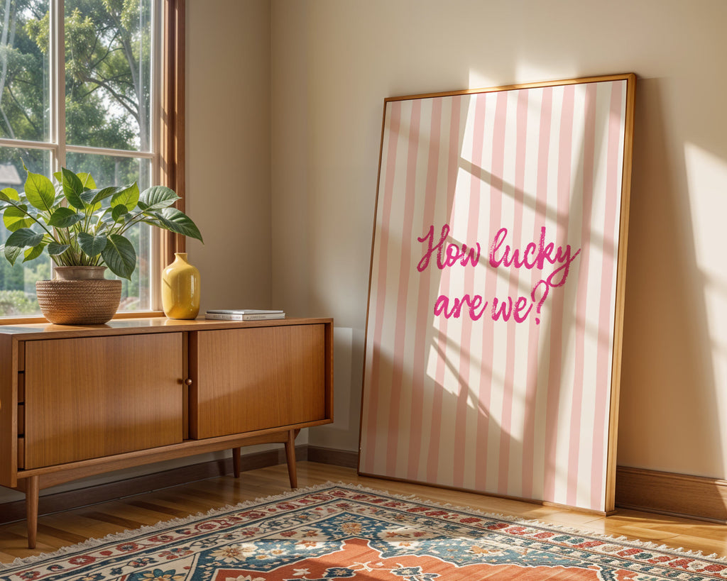 Room interior with a wooden sideboard, plant, and large framed picture with text.