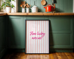 Framed print with 'How lucky are we?' text in a kitchen setting