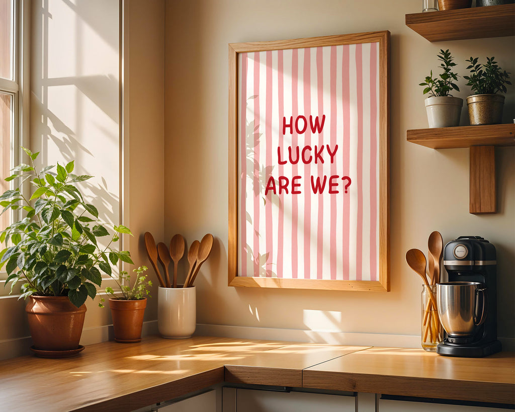 Kitchen corner with a framed picture, plants, and kitchen utensils.