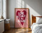 Framed artwork with a heart and text in a bedroom setting