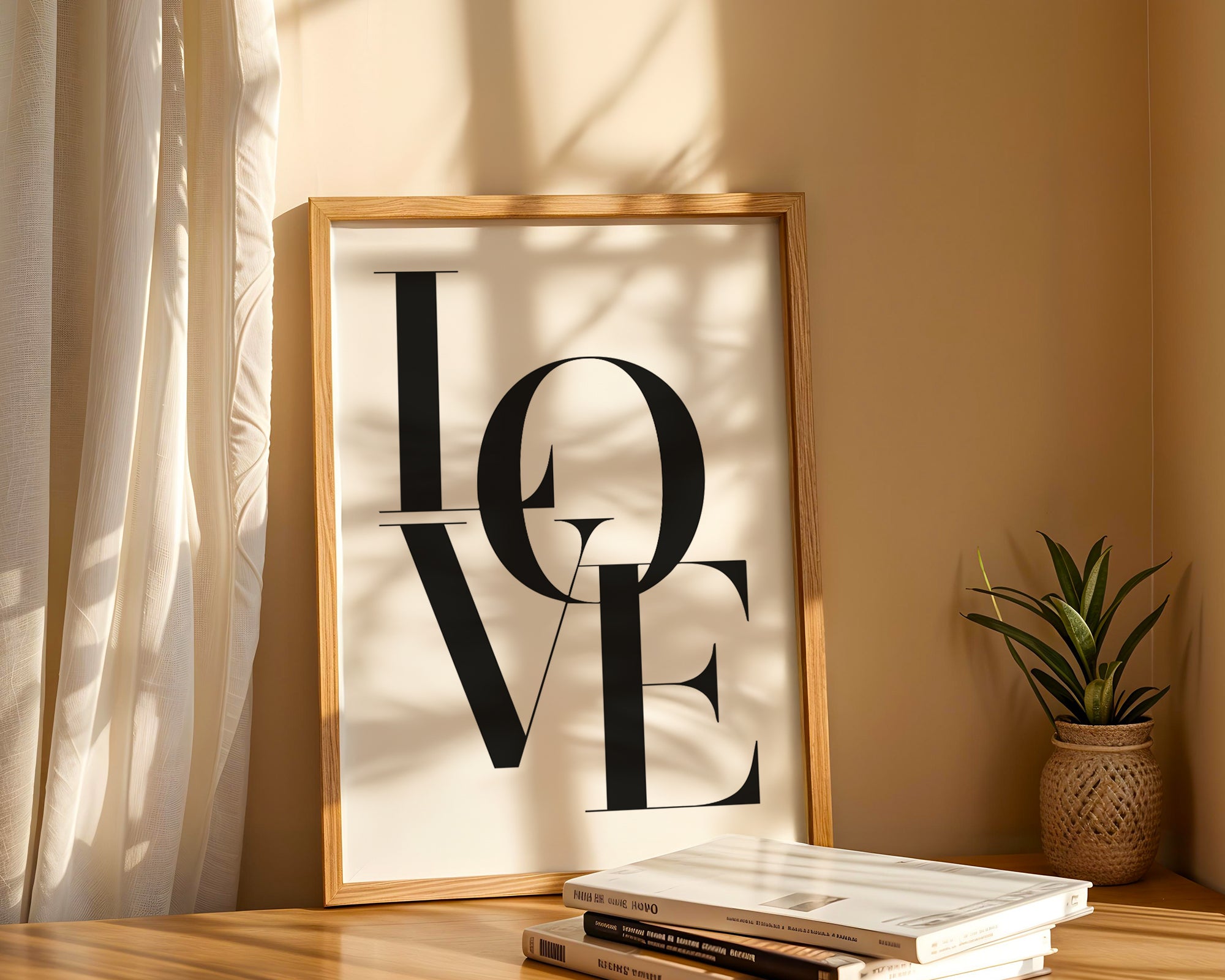 Framed 'LOVE' artwork on a shelf with books and a plant