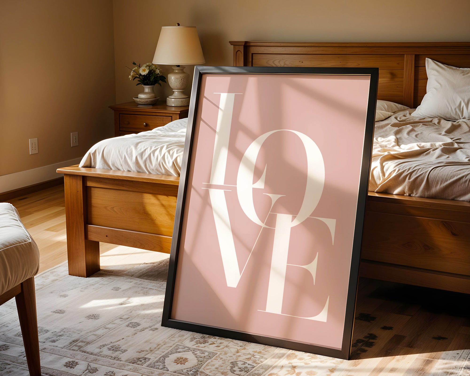 Framed 'LOVE' print on a bed in a bedroom