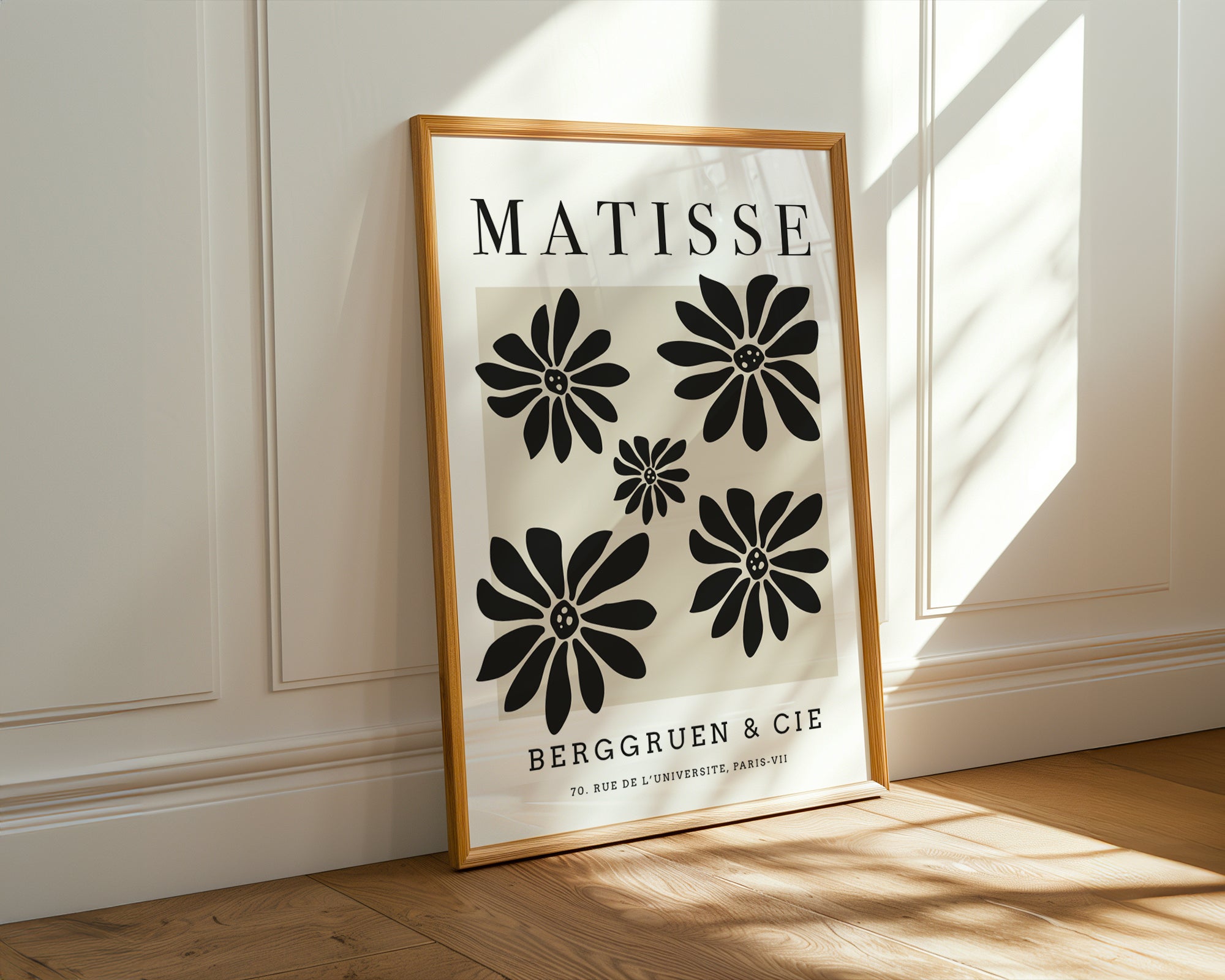 Framed Matisse art print on a wall with sunlight casting shadows.