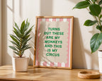 Framed quote on a wall with plants and a wooden surface