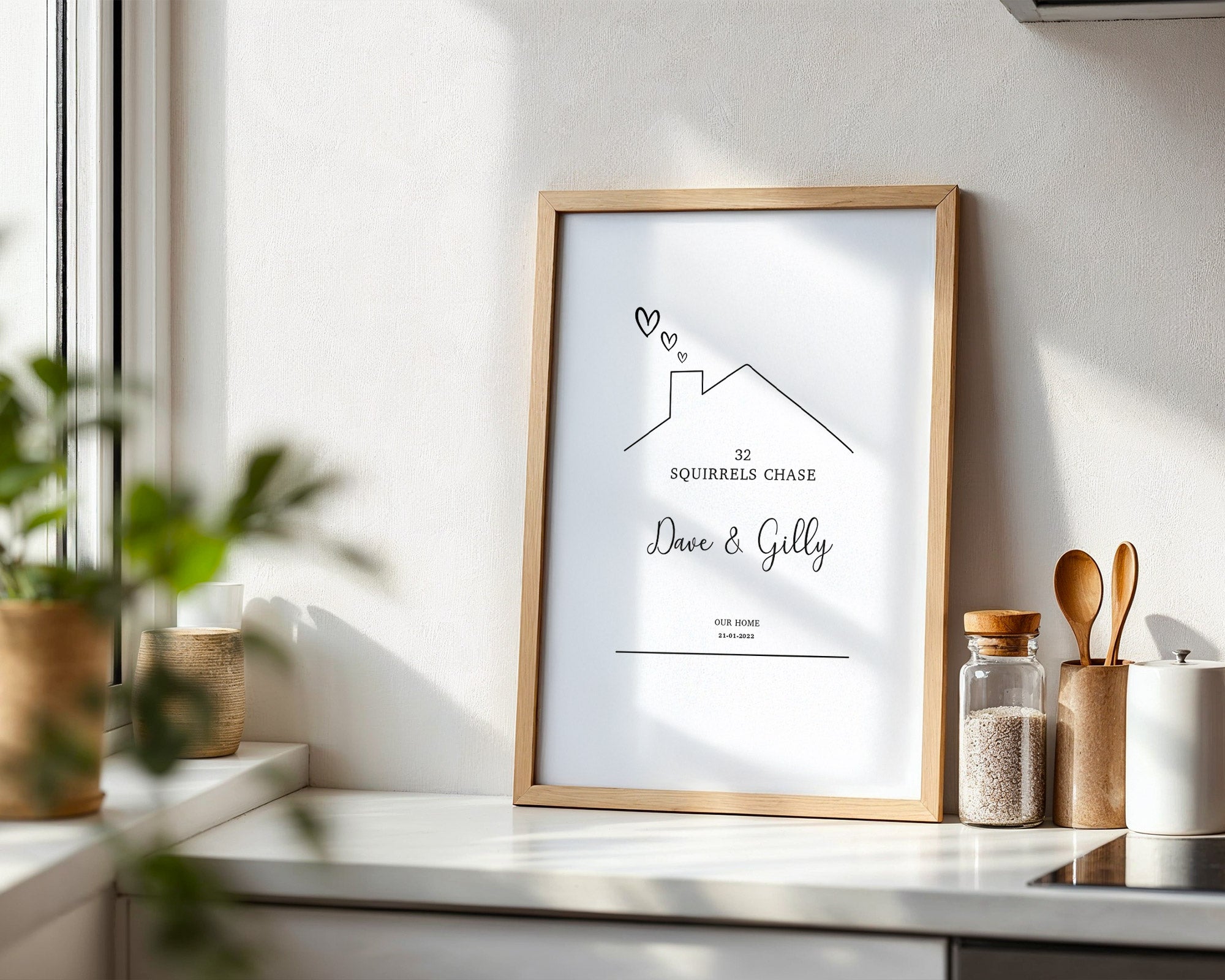 Framed artwork on a kitchen counter with decorative items