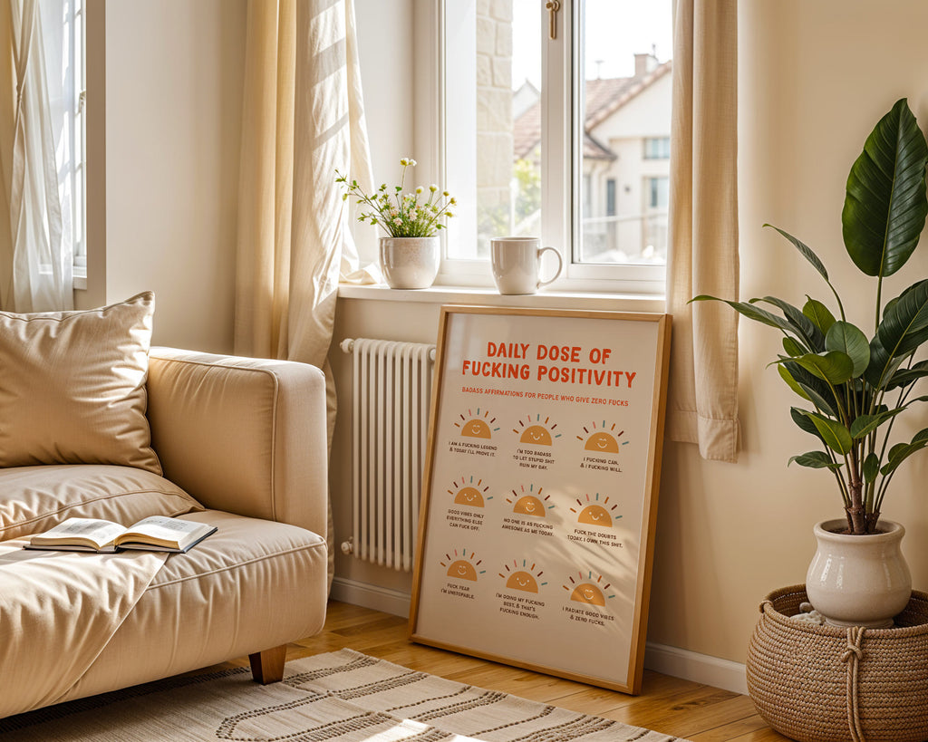Living room with a beige sofa, plant, and motivational poster on a wall.