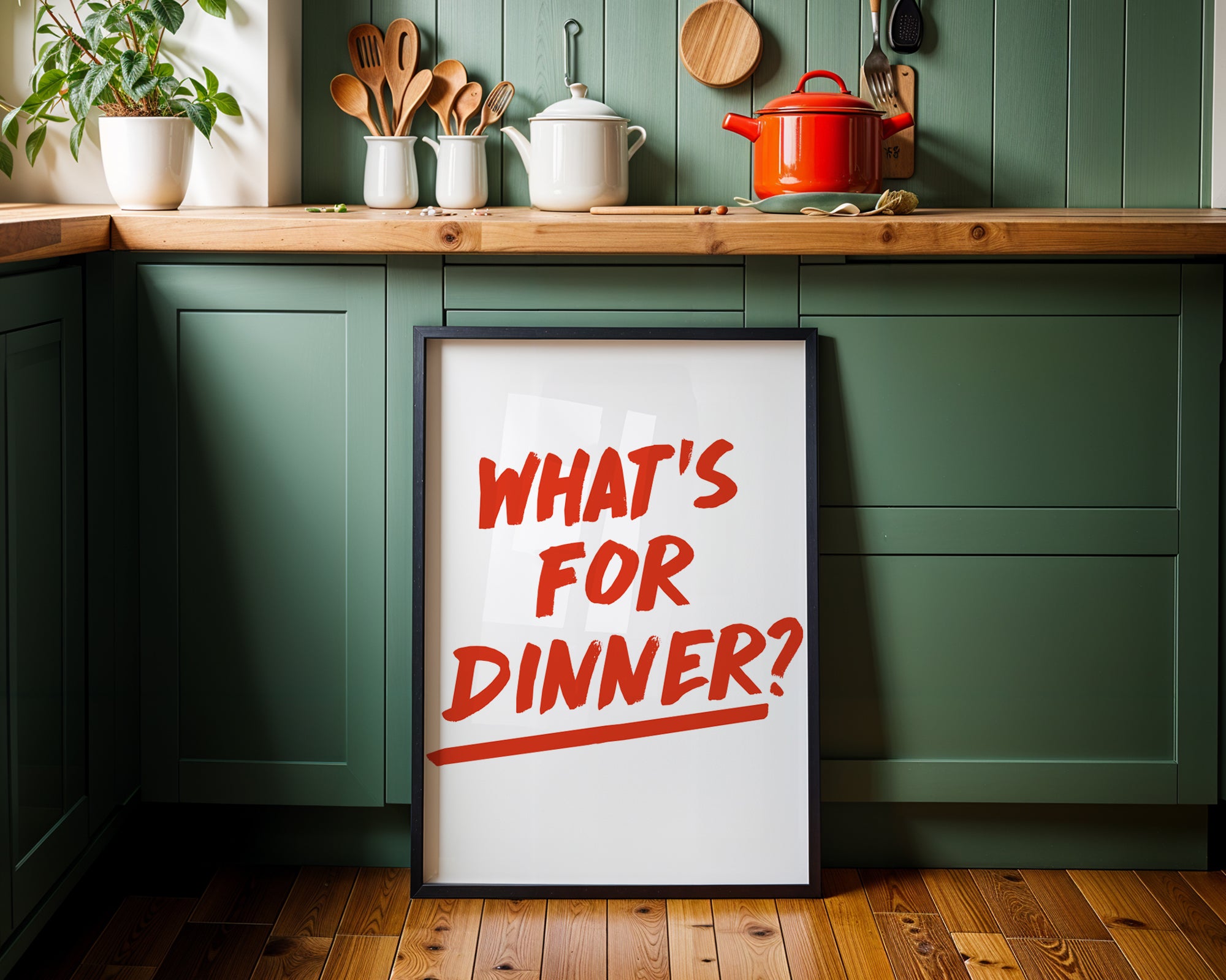 Kitchen setting with a framed poster asking 'What's for dinner?' on a green cabinet.