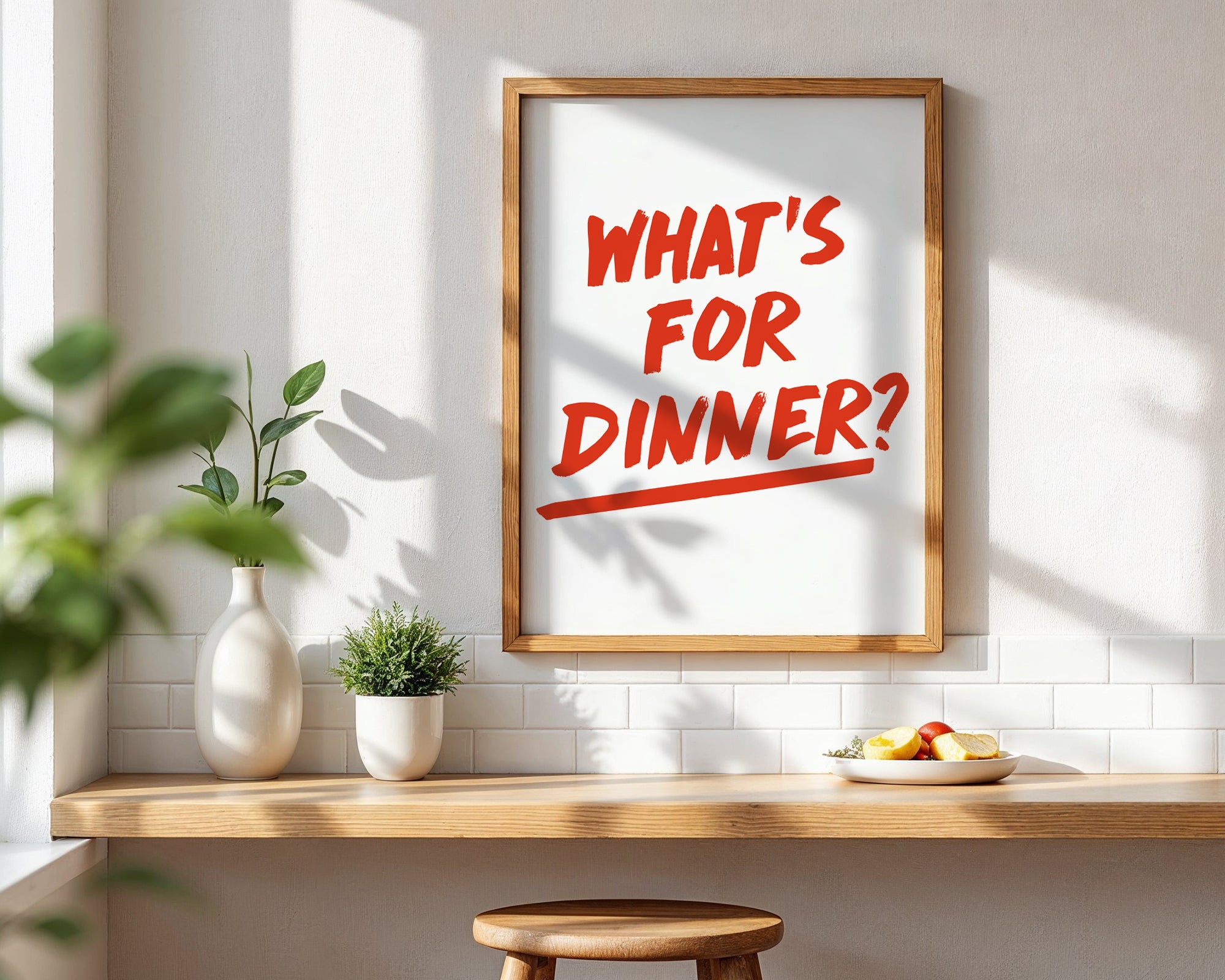 Framed poster with 'What's for Dinner?' text in a kitchen setting