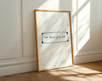 Framed artwork with a motivational quote on a white wall.
