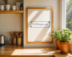 Kitchen counter with a framed quote, potted plants, and coffee cups.