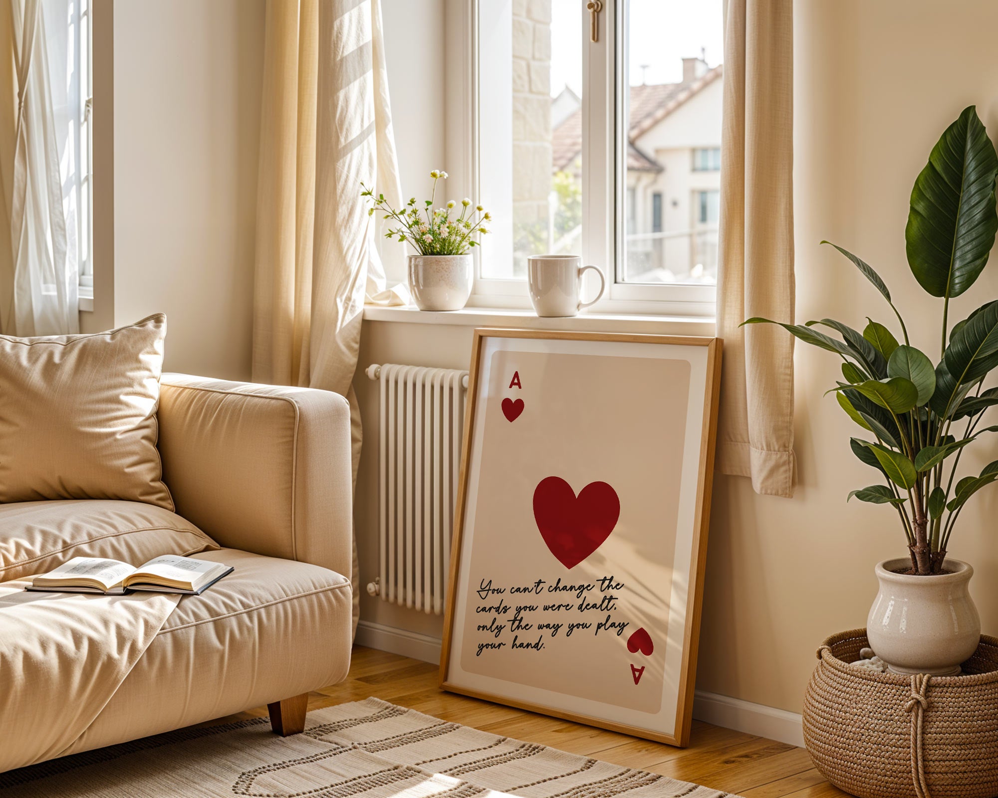 Cozy living room with a beige sofa, framed artwork, and plants.