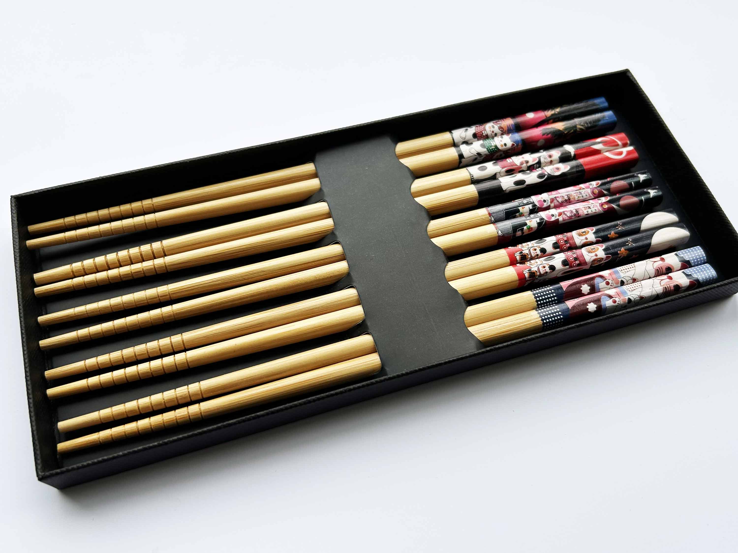 Set of chopsticks in a black box on a white background
