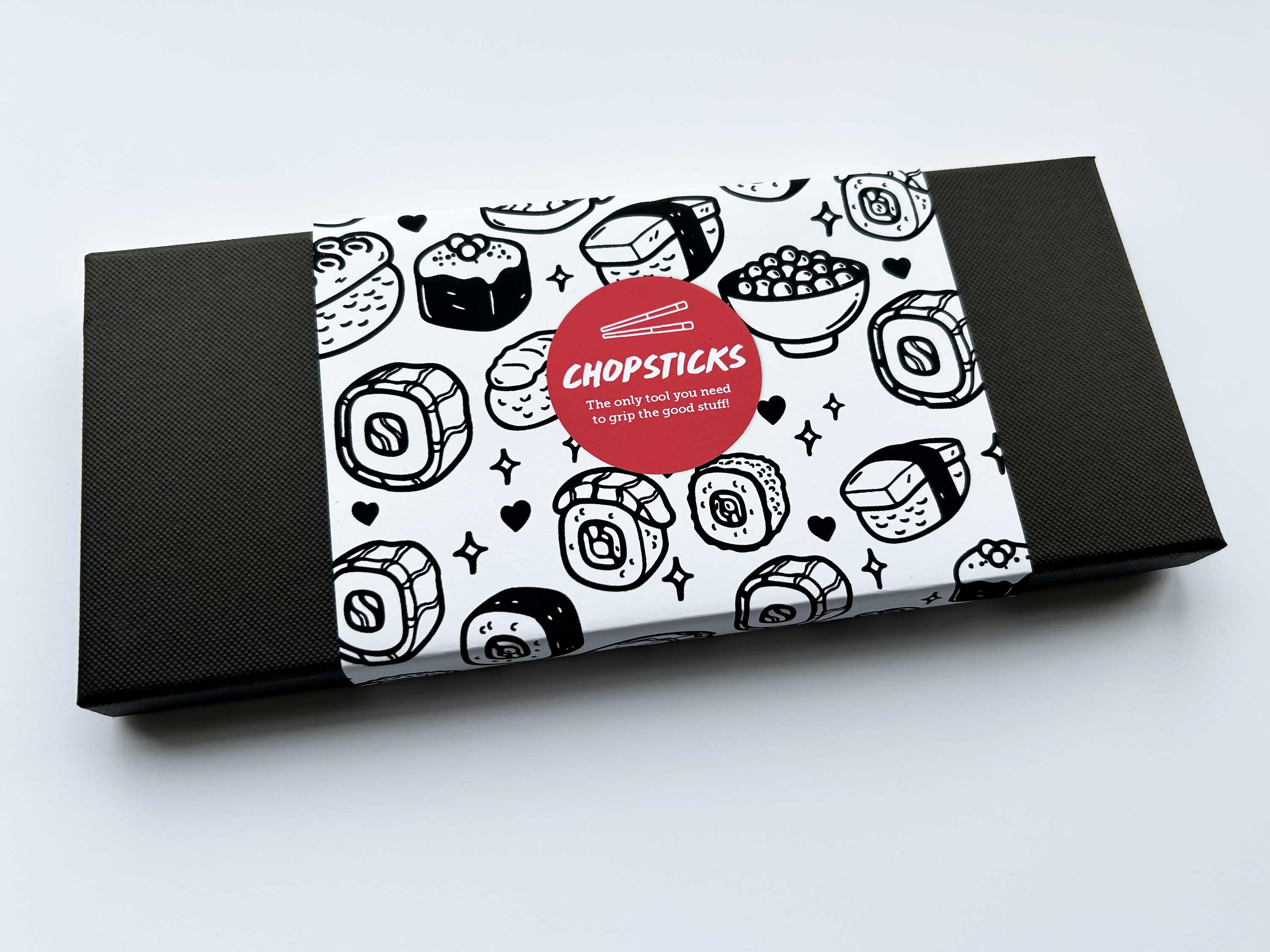 Packaging for chopsticks with a black and white sushi pattern on a white background