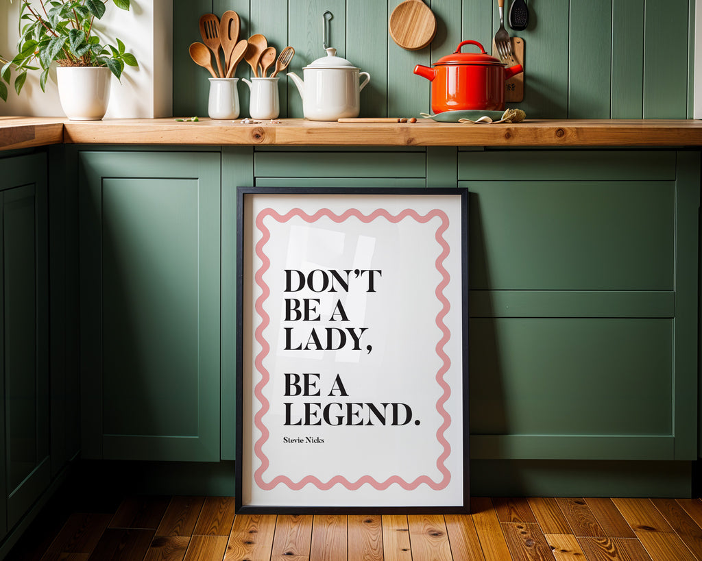 Kitchen interior with a framed quote on a green wall