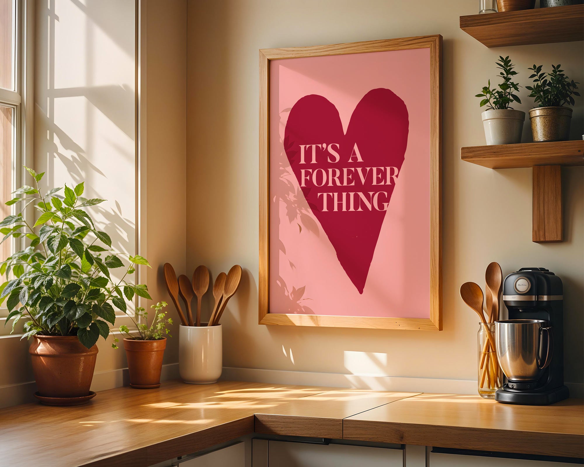 Kitchen counter with a heart-shaped poster, plants, and kitchen utensils.