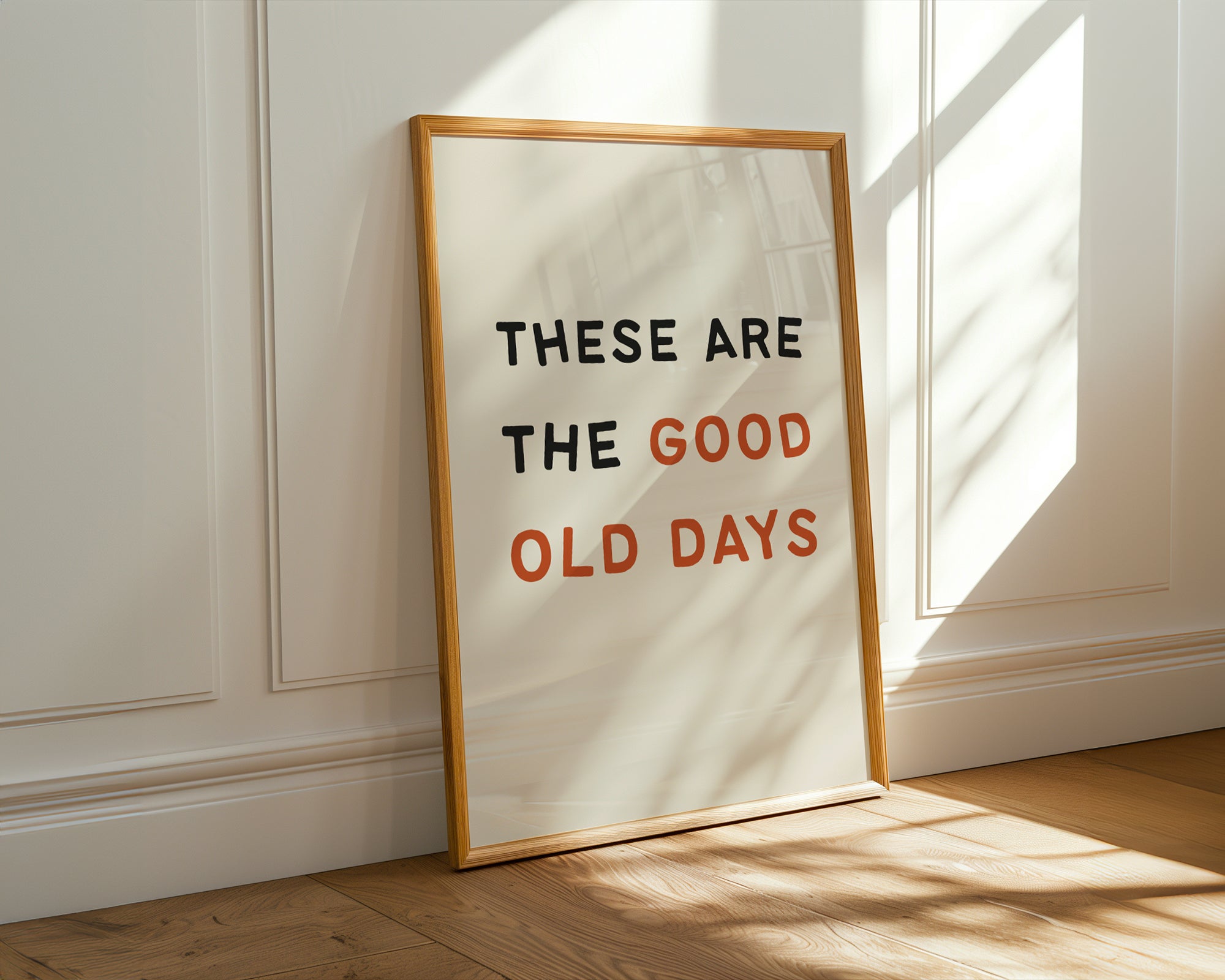 Framed poster with 'These are the good old days' text on a wall.