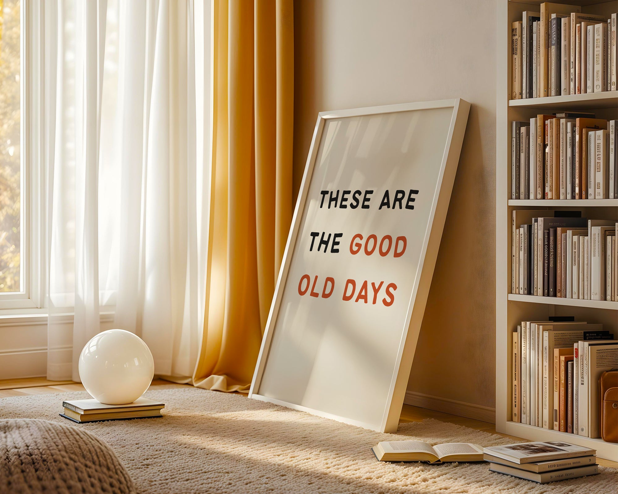 Framed quote 'These are the good old days' on a rug with books and decor around.
