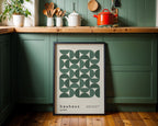 Kitchen interior with a bauhaus poster on a green wall.