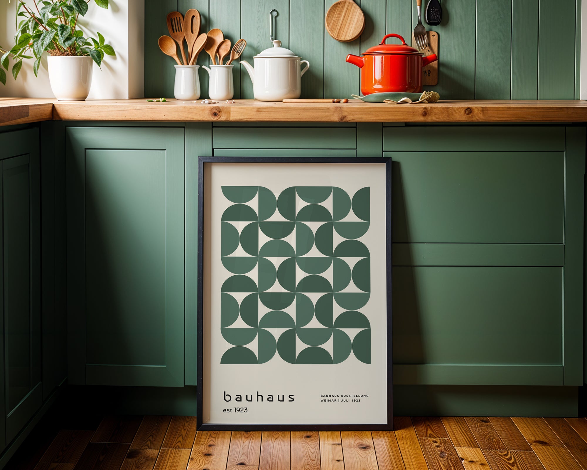 Kitchen interior with a bauhaus poster on a green wall.