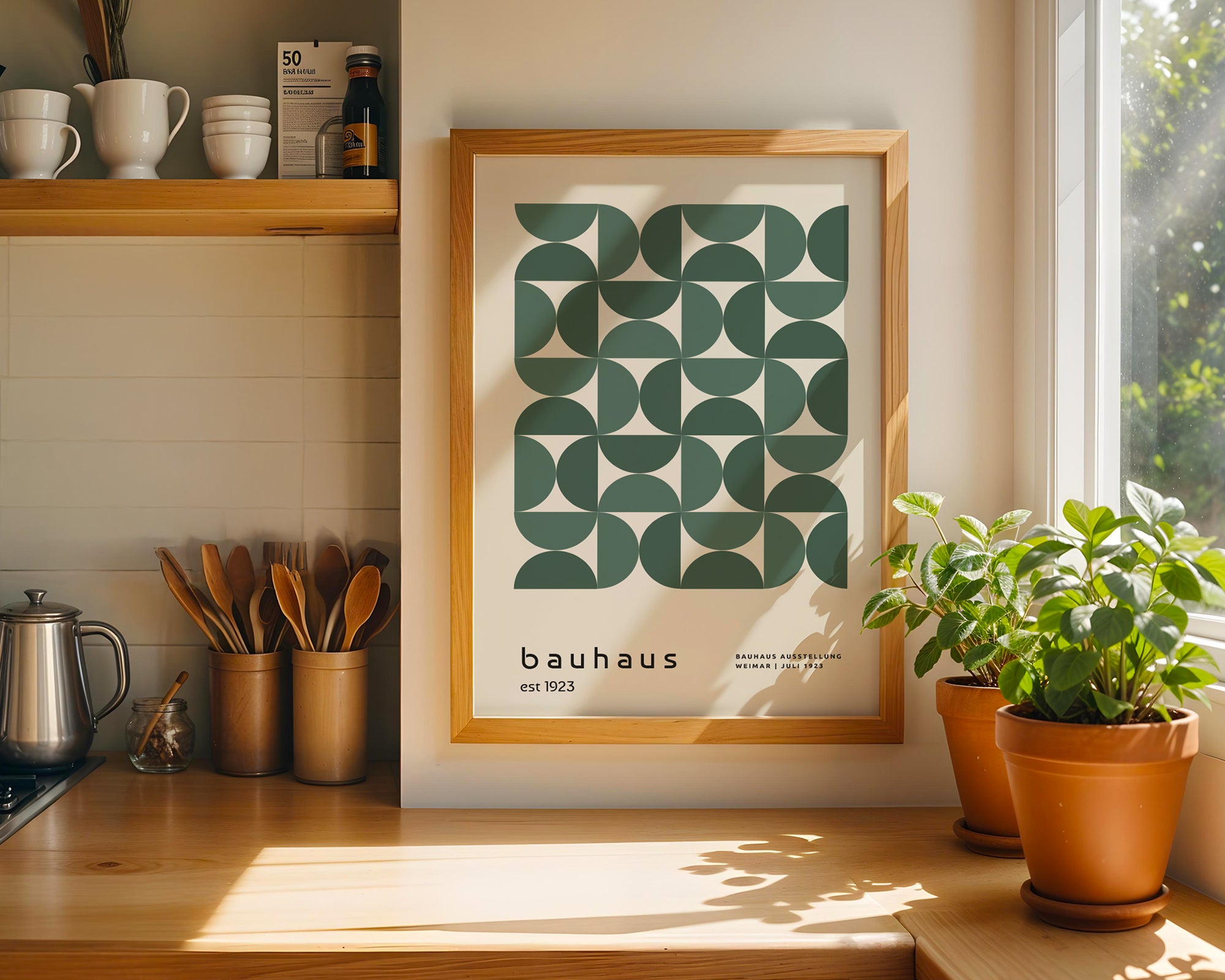 Framed Bauhaus poster on a kitchen wall with plants and kitchenware.