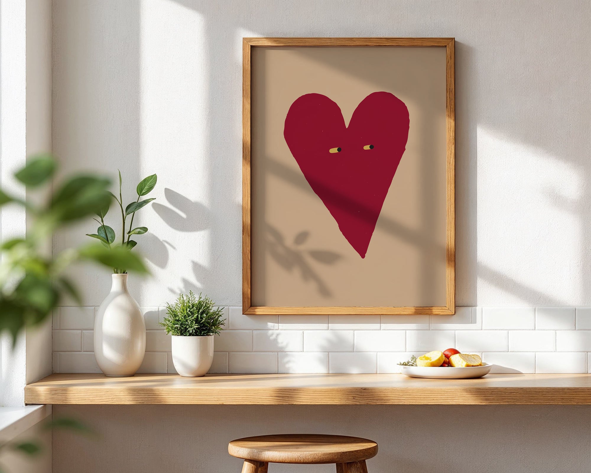 Framed red heart art piece on a wall with a wooden shelf below