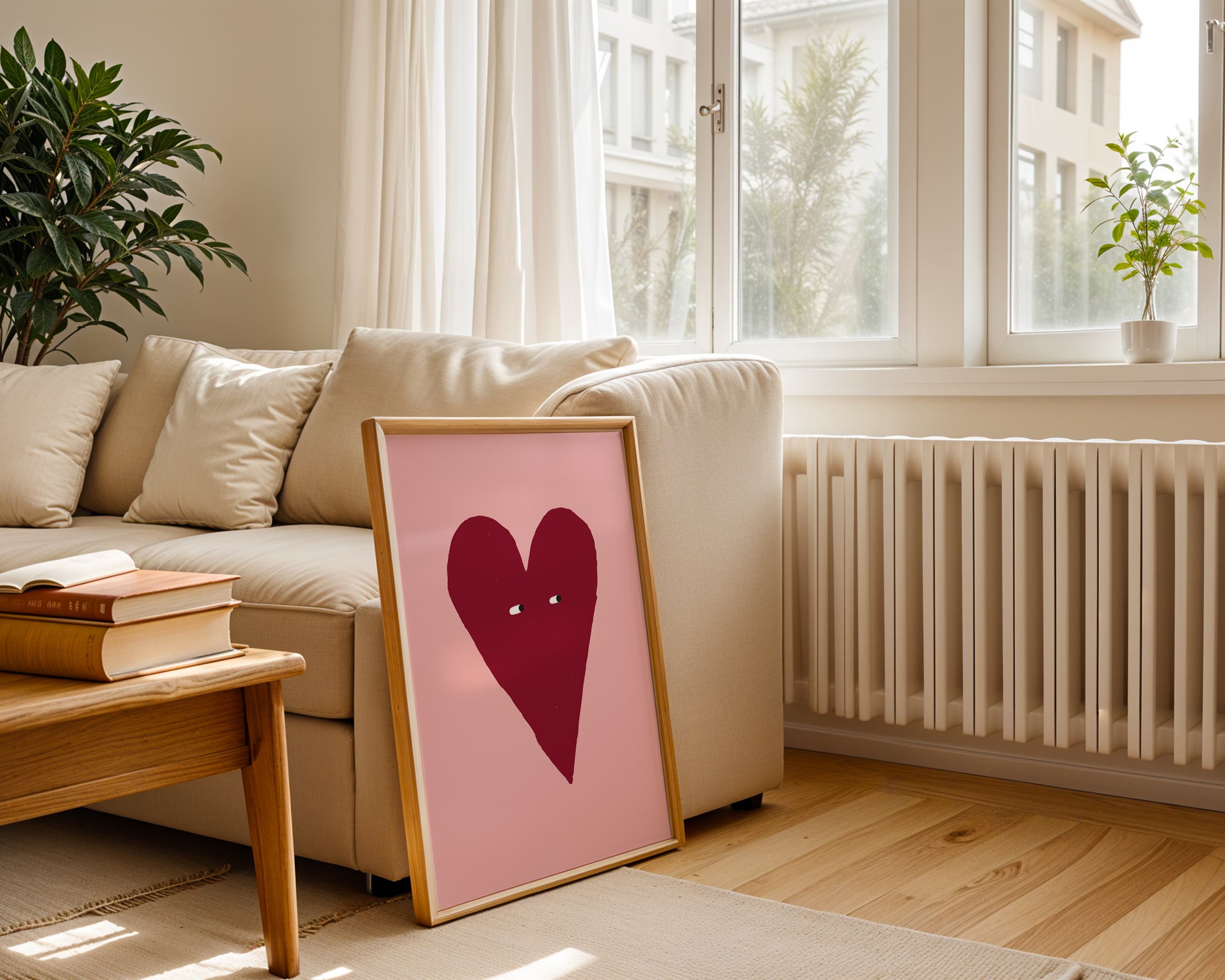 Heart-shaped picture on a table in a living room with a couch and window in the background