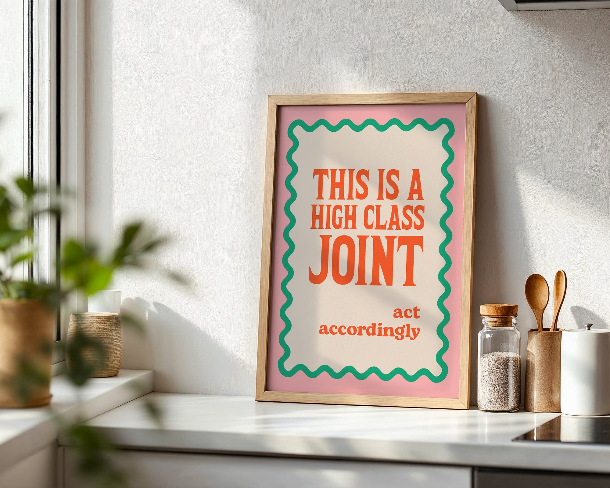 Framed poster with humorous text on a kitchen counter