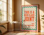 Framed poster with text 'This is a high class joint, act accordingly' in a sunlit room.