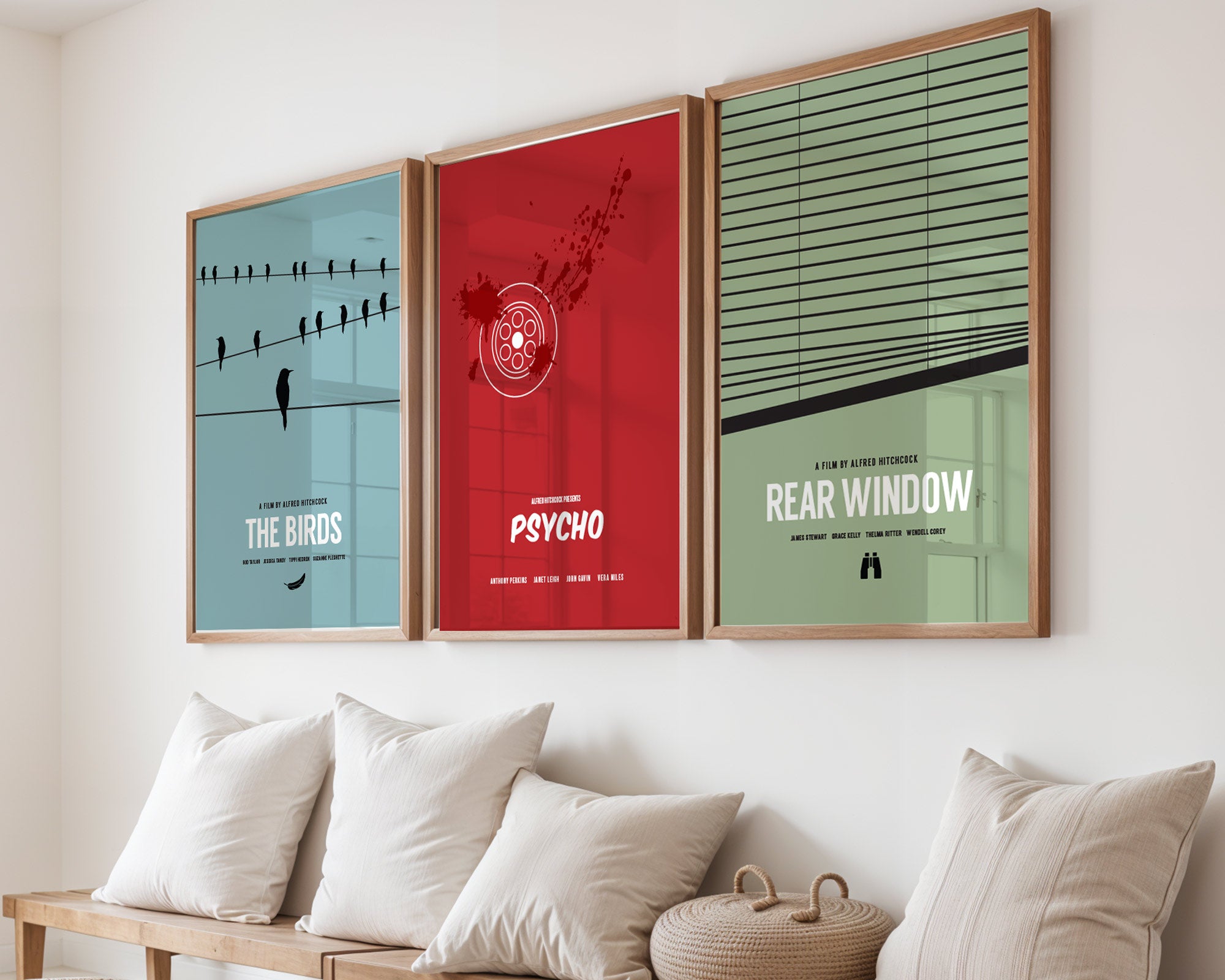Three movie posters titled 'The Birds', 'Psycho', and 'Rear Window' on a wall above a sofa.