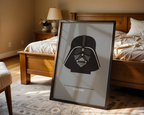Framed Darth Vader poster on a bed in a bedroom