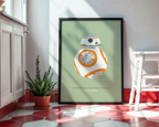 Framed poster of BB-8 from Star Wars on a wall in a room with a plant and cabinet.
