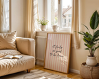 Cozy living room with a beige sofa, plant, and framed quote on a wall.
