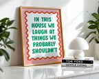 Framed sign with humorous text on a shelf with books and plants