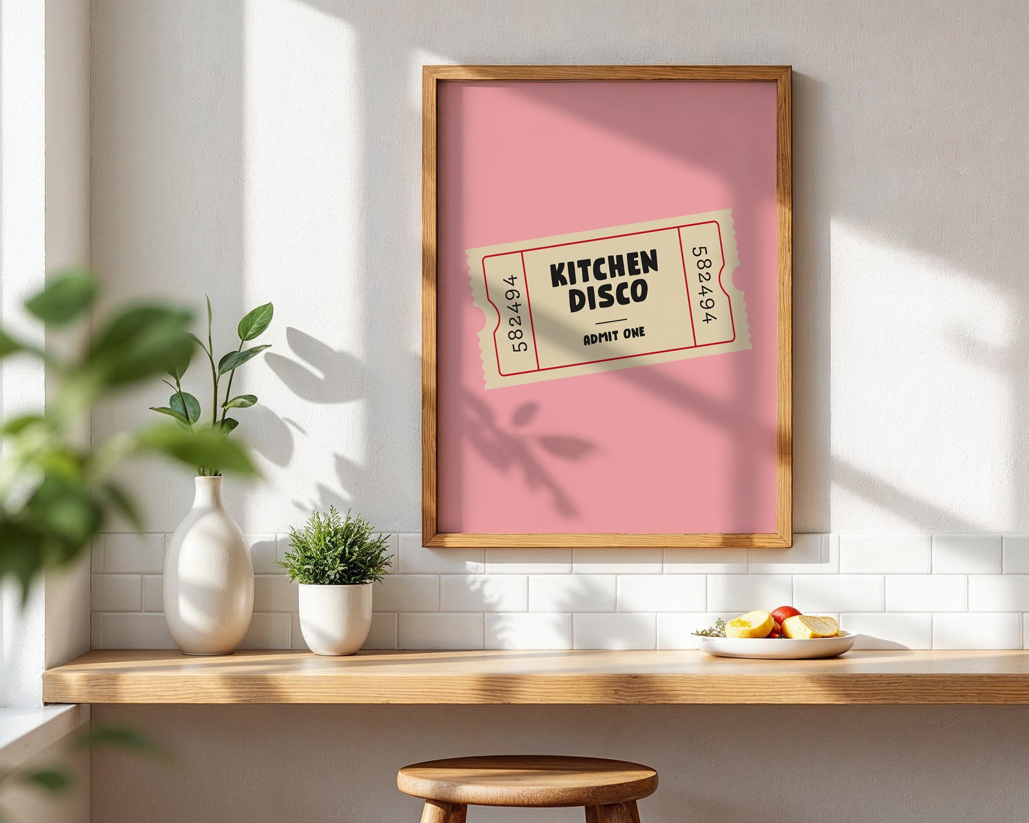Framed poster with 'Kitchen Disco' design on a wall in a kitchen setting.