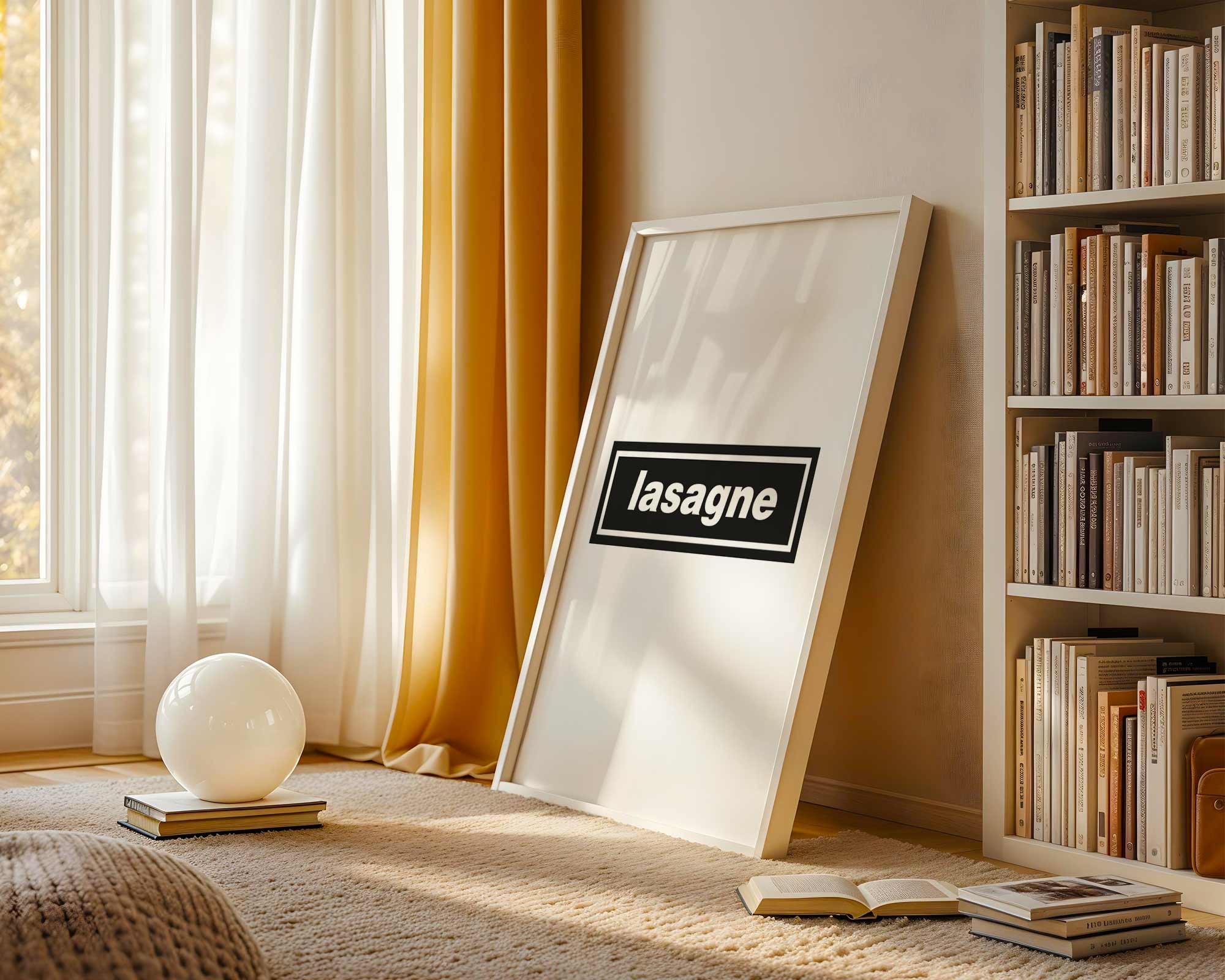 Framed picture with 'lasagne' text leaning against a wall in a room with books and decor.