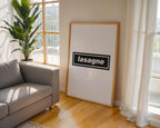 Living room with a gray sofa, framed picture of lasagne, and large window.