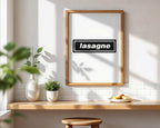Framed picture with 'lasagne' text on a wall in a kitchen setting