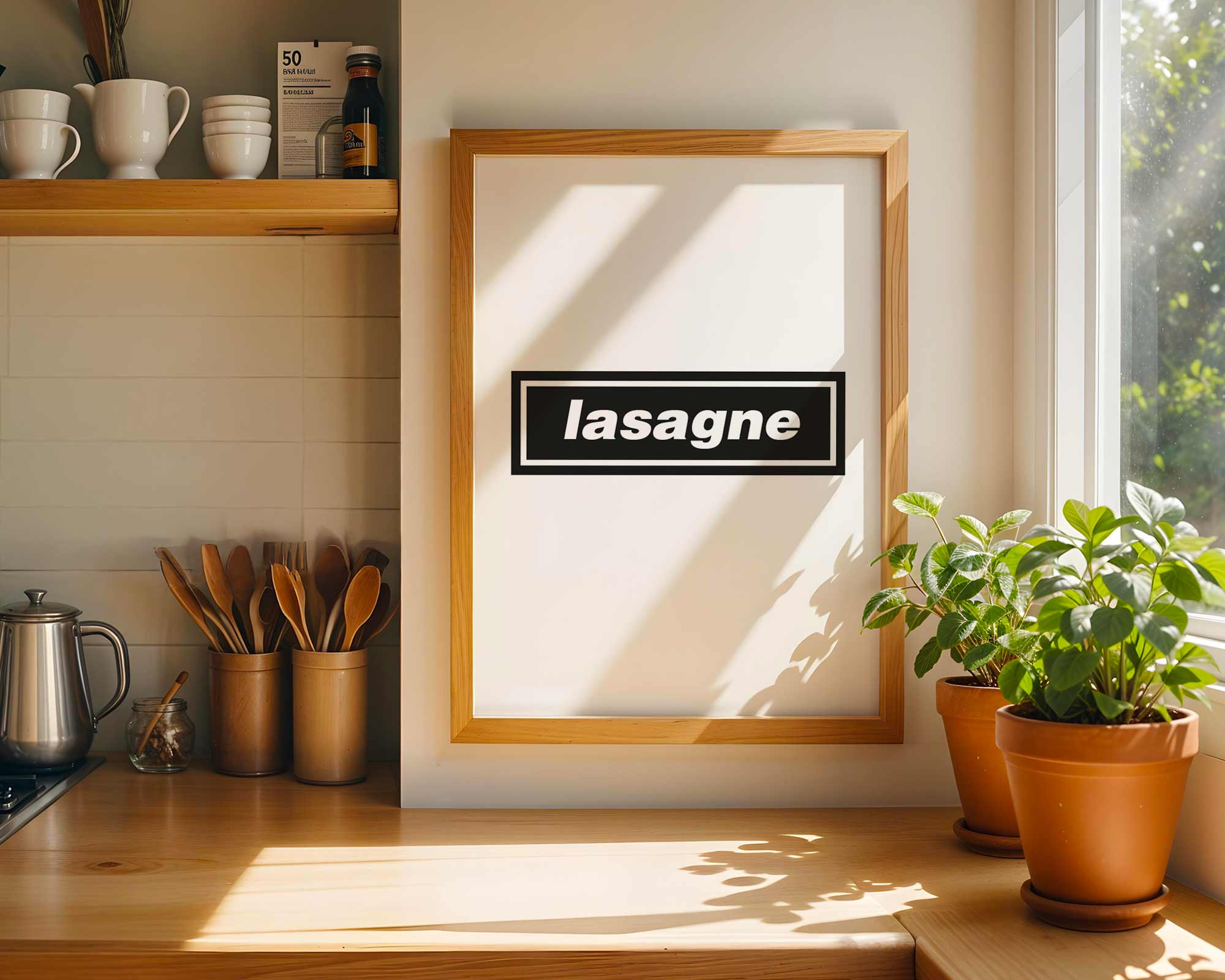 Kitchen counter with framed picture labeled 'lasagne', potted plants, and kitchen utensils.