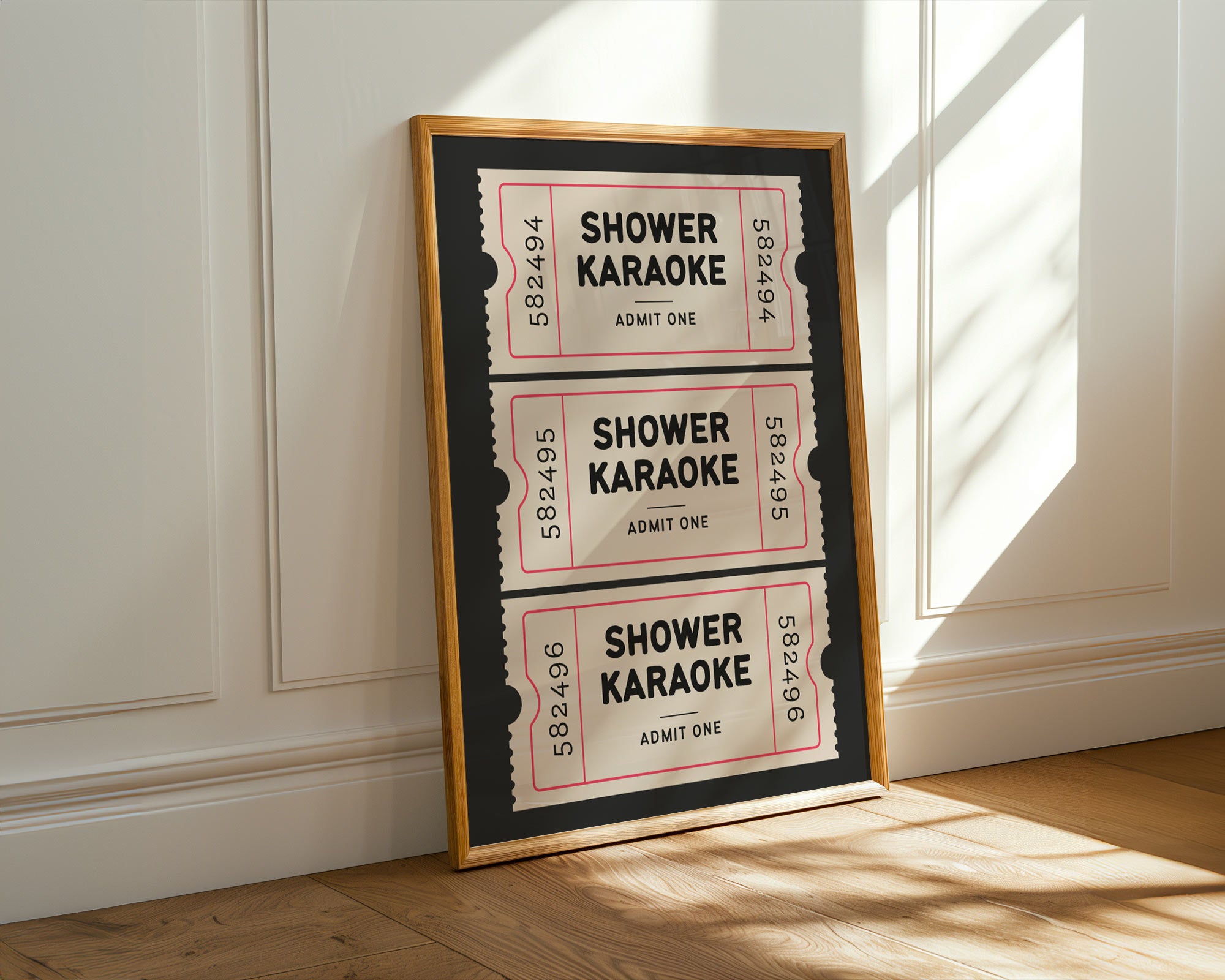 Framed poster with 'Shower Karaoke' tickets on a wall.