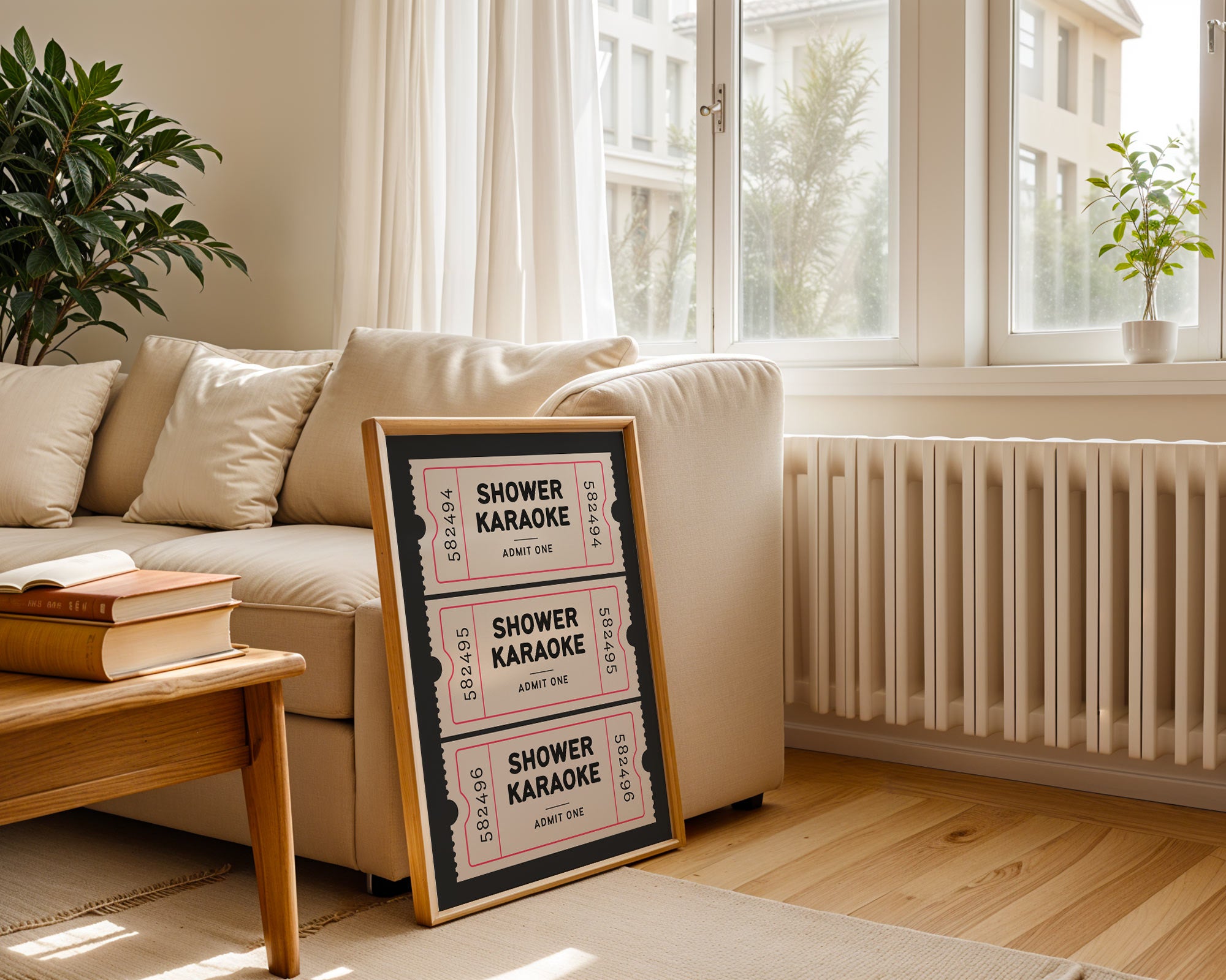 Framed 'Shower Karaoke' sign on a coffee table in a living room with a couch and plants.