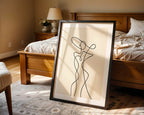 Framed abstract artwork of a woman in a bedroom setting