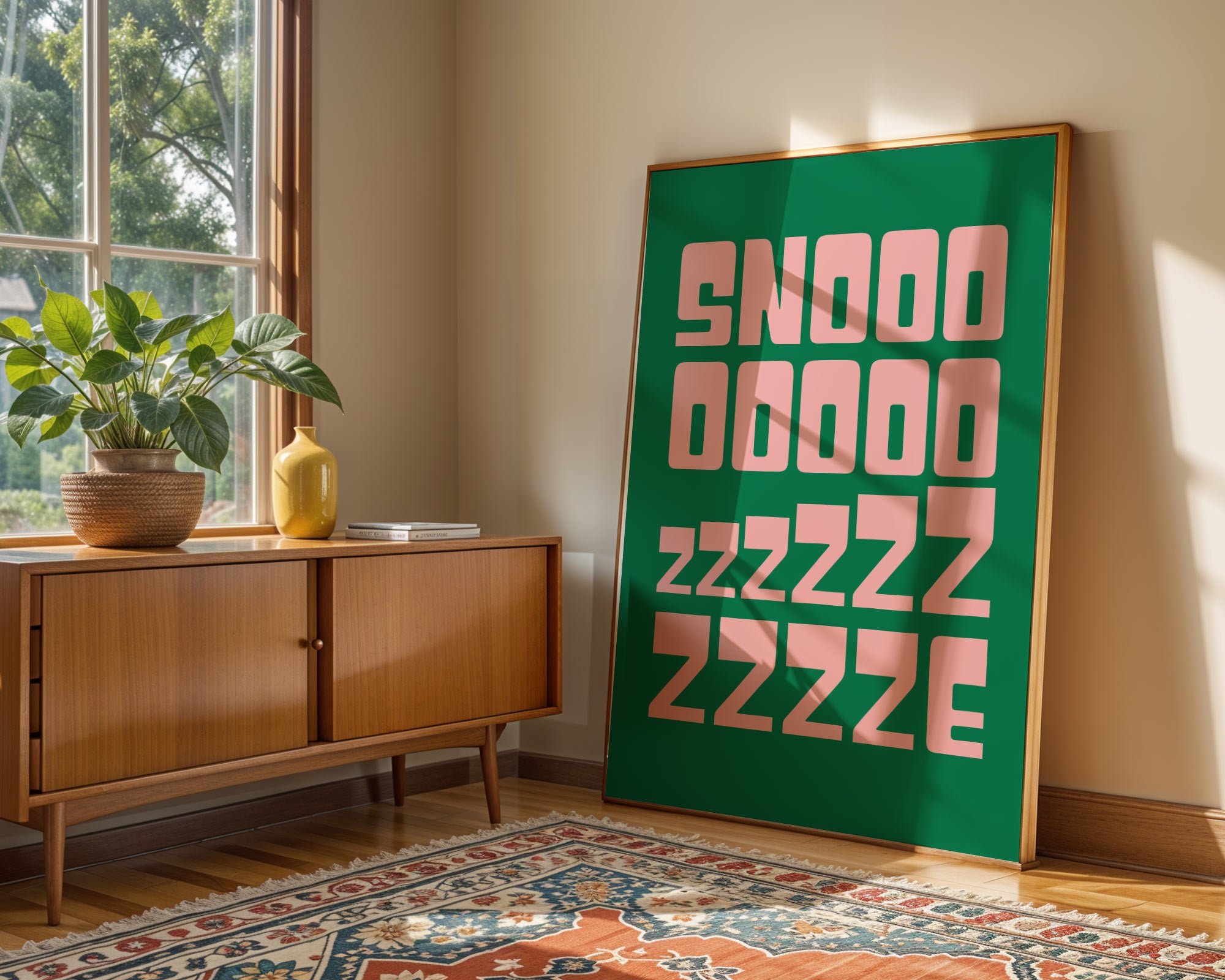Room interior with a wooden sideboard, plant, and large framed poster on the wall.