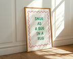Framed print with 'Snug as a bug in a rug' text on a wall.