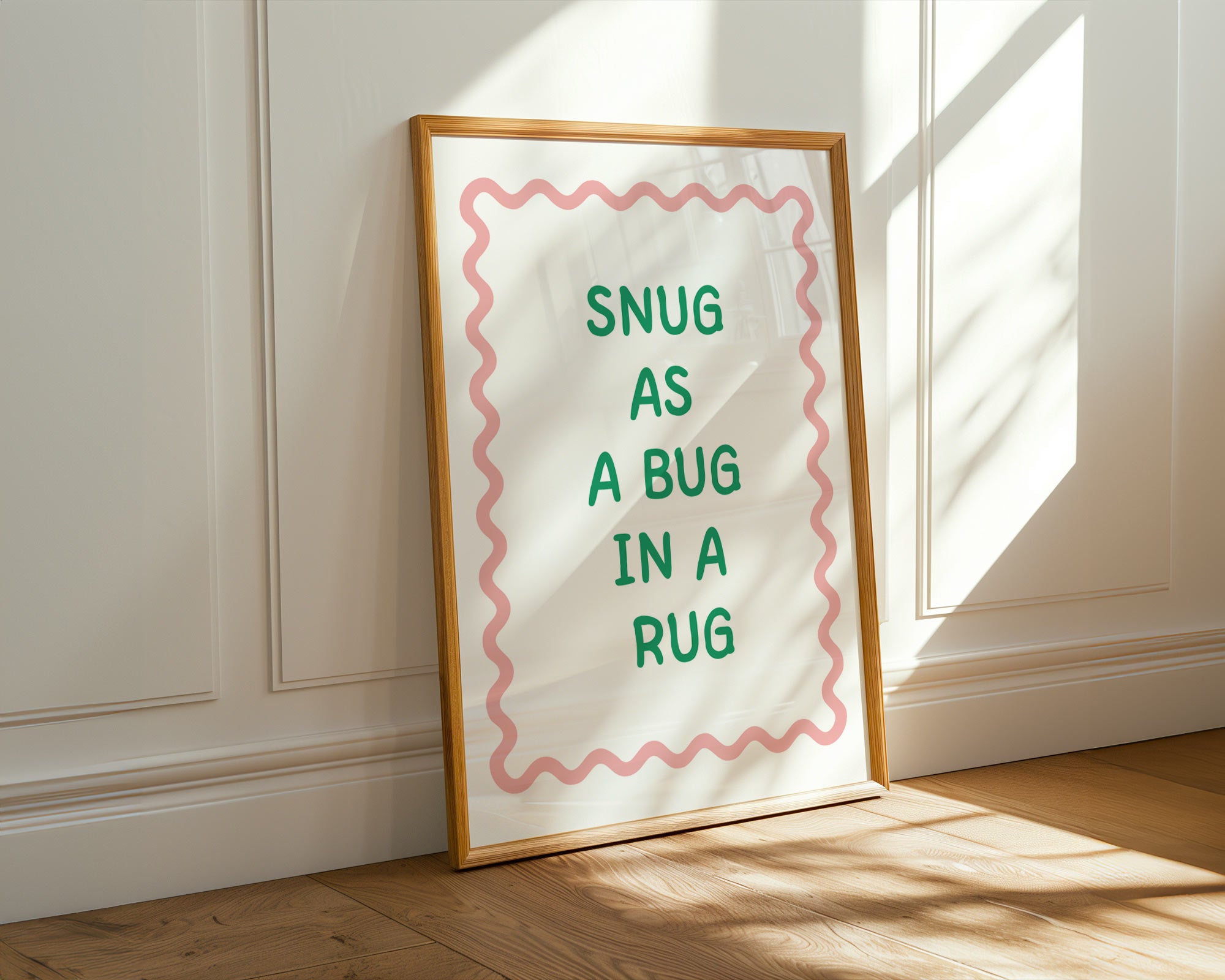 Framed print with 'Snug as a bug in a rug' text on a wall.